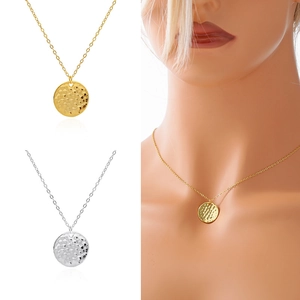 Detail of hammered round disc pendant necklaces in gold and silver finishes