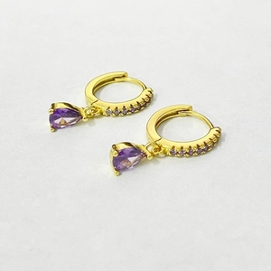 Detail of gold-plated S925 silver hoop earrings with pear-cut purple zircon drops