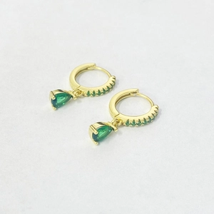Detailed view of gold hoop earrings with green pear-cut crystal charms and pavé accents