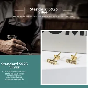 Detail shot of gold S925 sterling silver bar stud earrings with pavé micro zircons