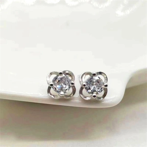 Detailed view of silver clover earrings with a center-set round-cut sparkling zircon