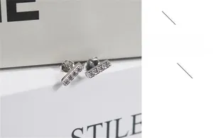 Macro shot of S925 sterling silver bar earrings with white zircon inlay details