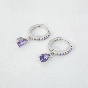 Detail view of S925 silver hoop earrings with pear-cut purple zircon stone pendants
