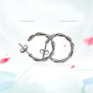 Dettaglio di orecchini a cerchio intrecciati in argento sterling S925 con finitura