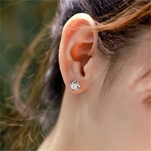 Close-up of S925 silver clover stud earring with sparkling cubic zirconia on model