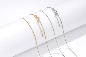 Detail view of adjustable S925 sterling silver box chain with needle end and ball slider