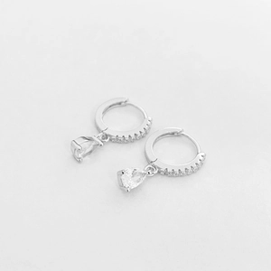 Detailed macro view of S925 silver hoop earrings with pear-cut cubic zirconia drops
