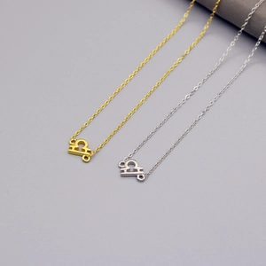 Detailed view of Libra zodiac symbol pendants in gold and silver finish with delicate O-chains