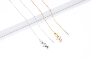 Macro detail of S925 sterling silver stamp on adjustable gold and silver cable chains