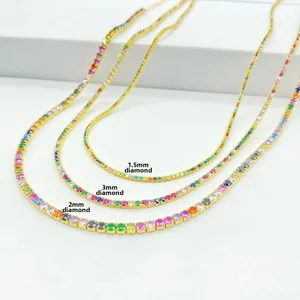 Detail view of 1.5mm, 2mm and 3mm gold rainbow tennis necklaces with colorful zircons