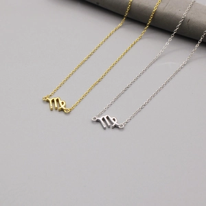 Detail view of Virgo zodiac pendants in gold and silver finish with minimalist O-chains