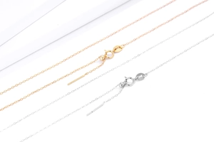 Macro detail of adjustable S925 sterling silver needle chain with slider bead and S925 stamp