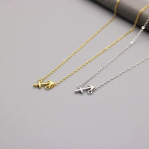 Detail of minimalist 925 sterling silver Sagittarius zodiac necklaces in gold and silver