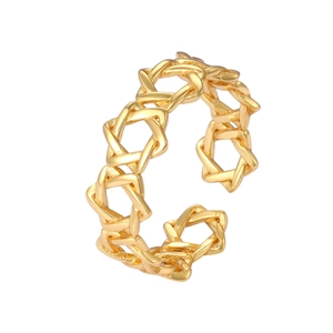 Macro detail of gold-plated open ring featuring a continuous hollow star of David pattern
