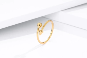 Macro view of gold s925 silver ring featuring geometric ball and arrow design