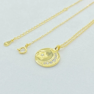 Macro view of S925 sterling silver hallmark on star moon gold necklace pendant