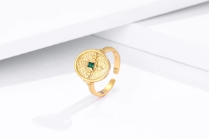 Macro detail of S925 hallmark on gold plated shield ring with green gemstone