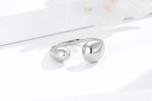 Macro detail of minimalist 925 sterling silver open ring with water drop design