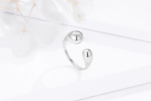 Detail view of 925 sterling silver open ring featuring high-polish golden droplet spheres