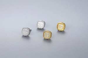 Detailed view of square stud earrings with pave zircon in gold and silver finishes