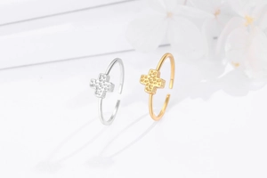 Macro detail of silver and gold cross rings featuring textured hammered finish
