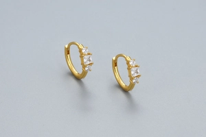 Close-up of gold-plated S925 silver hoop earrings featuring three zircon stones