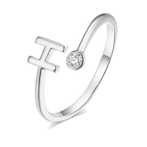 Detail view of silver open ring featuring an H letter design and a round cubic zirconia