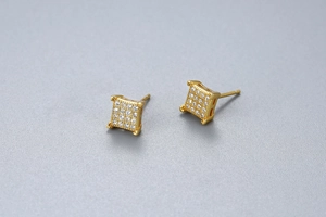 Macro detail of square S925 silver stud earrings with pave-set shimmering cubic zirconia
