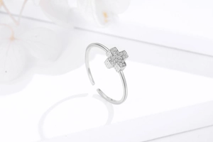 Close-up of adjustable 925 sterling silver ring with cross design and zircon stones