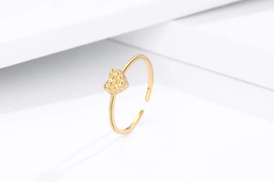 Detailed view of gold heart ring featuring a hammered lava texture and adjustable band