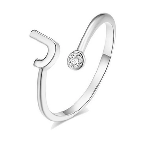 Close-up of silver open ring featuring letter J and sparkling cubic zirconia stone