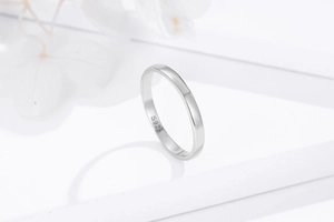 Detailed close-up of S925 hallmark on a polished minimalist sterling silver ring