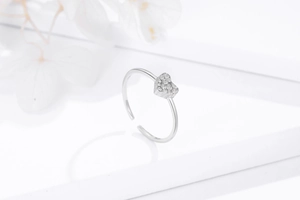 Macro shot of silver heart-shaped adjustable open ring with pave-set zircon detail