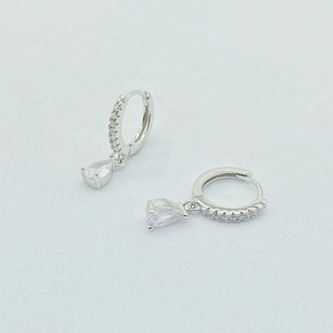 Detail of S925 sterling silver hoop earrings with pavé diamonds and pear-cut zircon drops