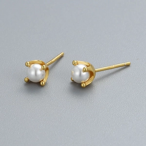 Elegant S925 sterling silver four-prong stud earrings featuring natural white round pearls