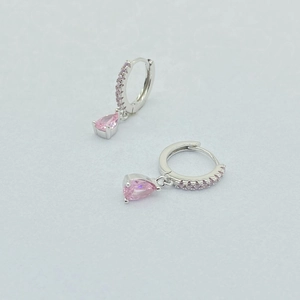Detail of silver drop earrings with pink pear-cut gemstone and pave rhinestones