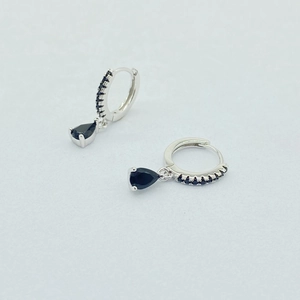 Close-up of S925 sterling silver drop earrings with black pavé stones and pear-cut charms