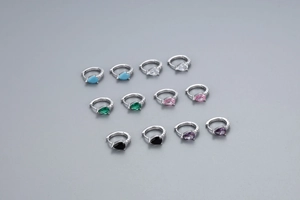 Détail de six paires de créoles en argent S925 avec des zircons colorés en forme de poire