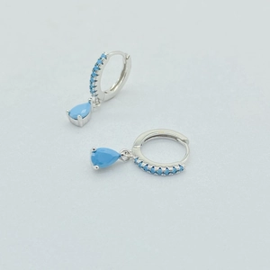 Close-up of S925 silver hoop earrings with blue water drop crystals and small stones