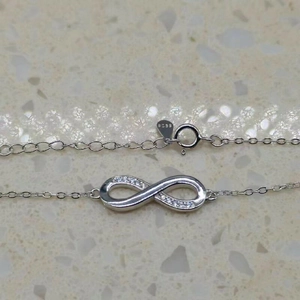 Detailed close-up of S925 sterling silver infinity bracelet with pavé cubic zirconia