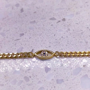 Bracelet œil porte-bonheur doré avec zircon bleu et chaîne gourmette plate