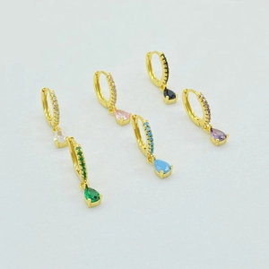 Detail view of colorful teardrop gemstone earrings with pavé crystals in gold settings
