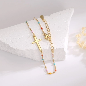 Macro shot of S925 sterling silver cross bracelet with multi-color beads on a stone