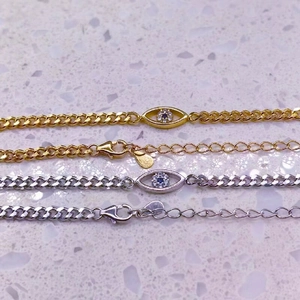 Détails de gourmettes œil porte-bonheur en or et argent avec zircon bleu brillant