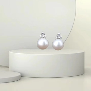 Elegant S925 sterling silver pearl stud earrings with sparkling diamonds on art display
