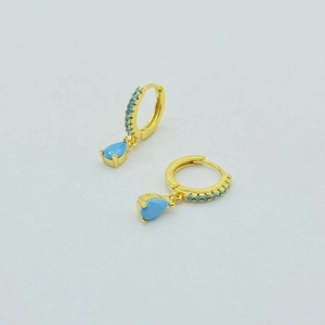 Detailed macro view of S925 silver hoop earrings with water-drop turquoise pendants