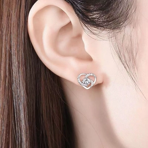 Close-up of s925 silver hollow heart stud earring with zircon on model's ear