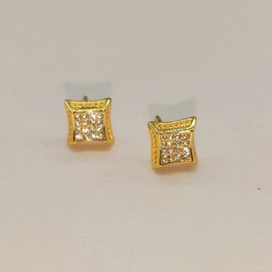Macro detail of square S925 silver stud earrings with pavé micro zircons in gold plating