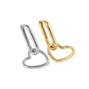 Detail view of gold and silver sterling silver hoop earrings with hollow heart pendants