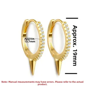 Close-up of S925 sterling silver earrings with 18K gold finish and conical spike charms